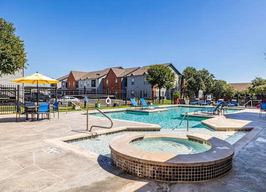 A pool with a hot tub in the middle of it at Clear Creek Meadows Apartments, Apartments, Copperas Cove, TX