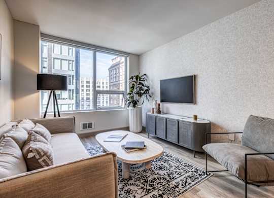 a living room with a couch and a chair and a television