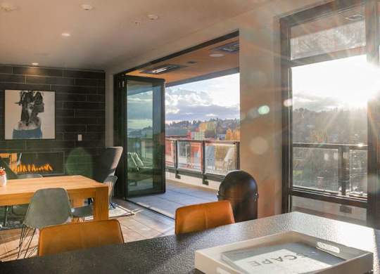 A modern dining room with a view of the mountains outside.at Axle, Washington, 98119
