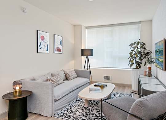 a living room with a couch coffee table and a window