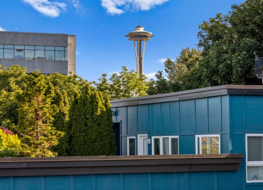 a blue building with a view of the space needle in the background  at Dexter Lake Union, Seattle, Washington