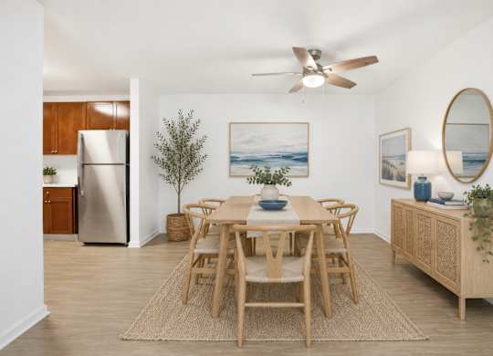 A dining room with a wooden table and chairs.