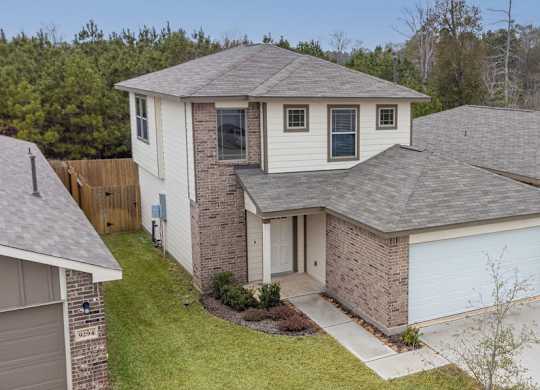 A house with a grey roof and a white garage door.
