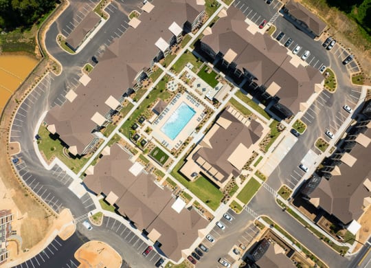 an aerial view of a neighborhood with houses and a pool