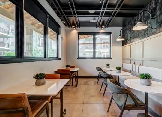a restaurant with tables and chairs and large windows