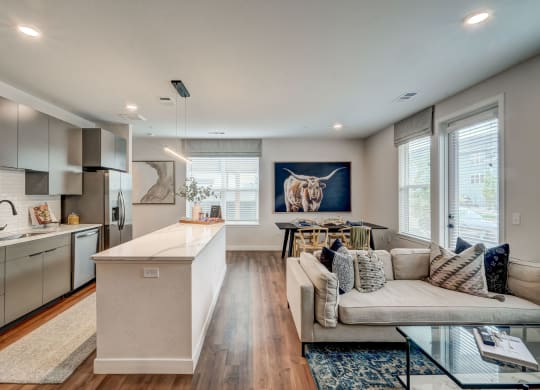 a living room with a kitchen and a couch