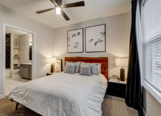a bedroom with a bed and a ceiling fan