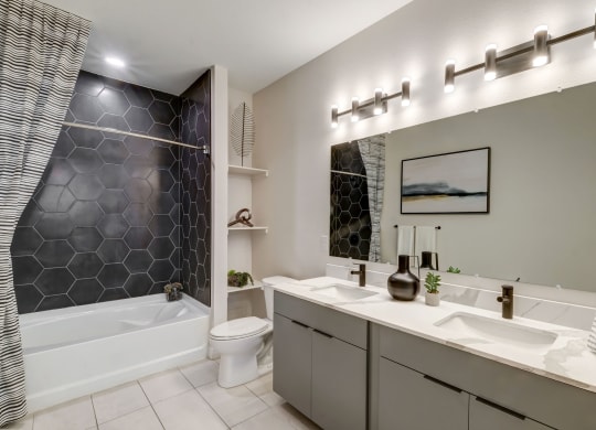 a bathroom with a sink and a toilet and a tub