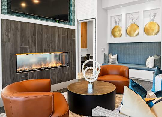 A modern living room with a fireplace and a TV above it.