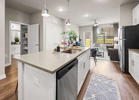 A modern kitchen with a large island and a view of the backyard.