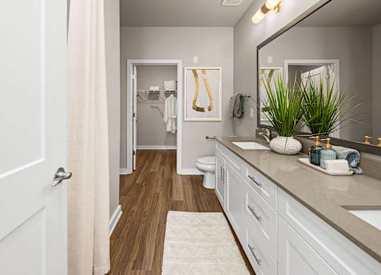 A bathroom with a white door and a white sink.