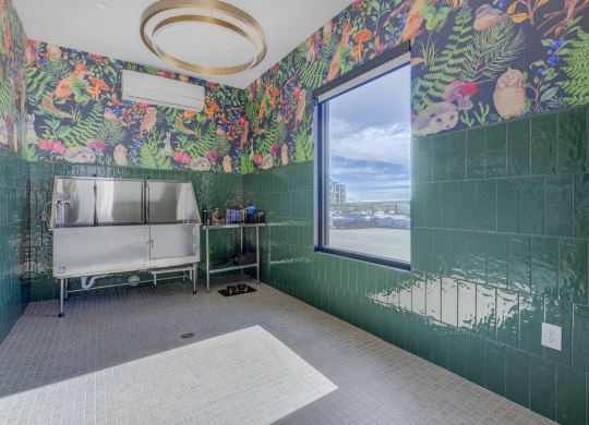 a bathroom with green tiled walls and a large window  at Embold, Utah, 84043