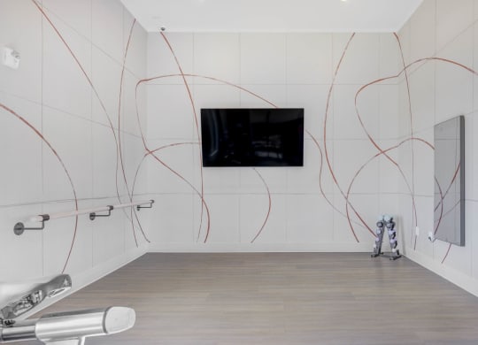 a large room with white walls and a flat screen tv on the wall  at Embold, Lehi, UT, 84043