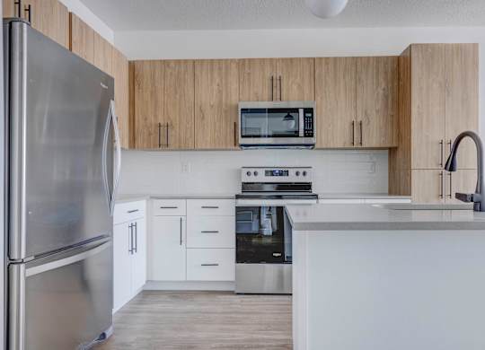 a kitchen with white cabinets and stainless steel appliances