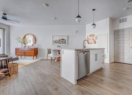 a kitchen and dining room with a stainless steel refrigerator