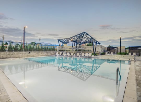 a large pool with a shade structure in the background