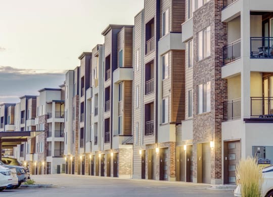 an exterior view of an apartment building at dusk