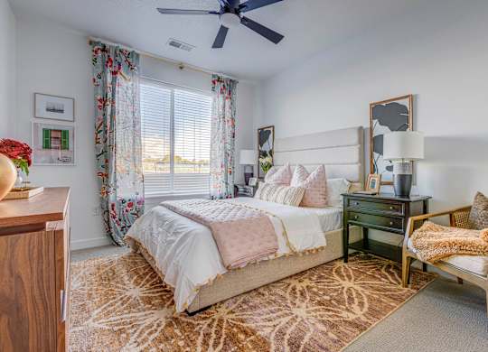 a bedroom with a bed and a ceiling fan