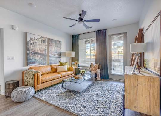 a living room with a couch and a ceiling fan