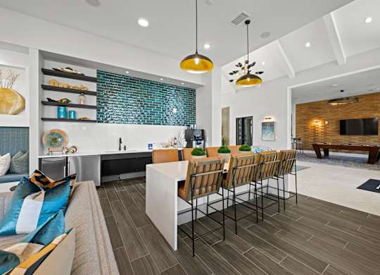 A modern kitchen with a dining table and chairs.