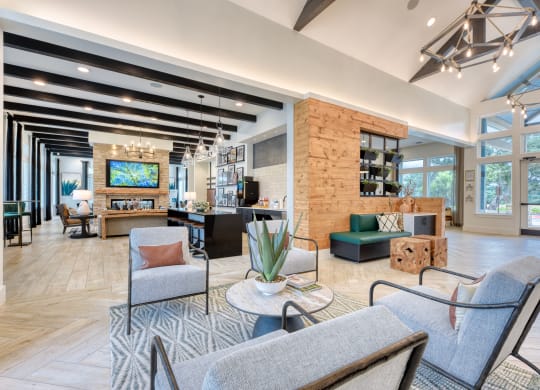a resident clubhouse with couches chairs and a coffee table