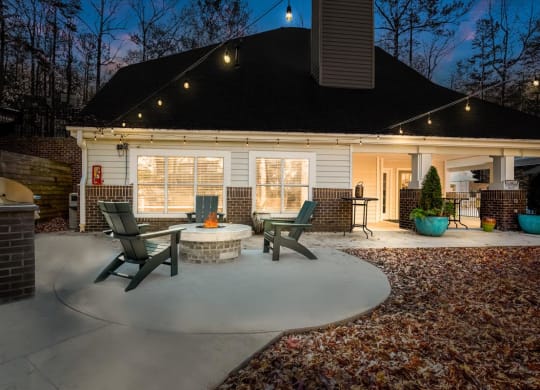a circular concrete patio with a fire pit in the middle