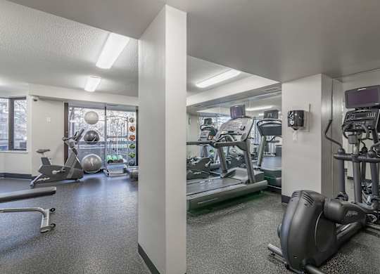 a gym with treadmills and other exercise equipment in a building