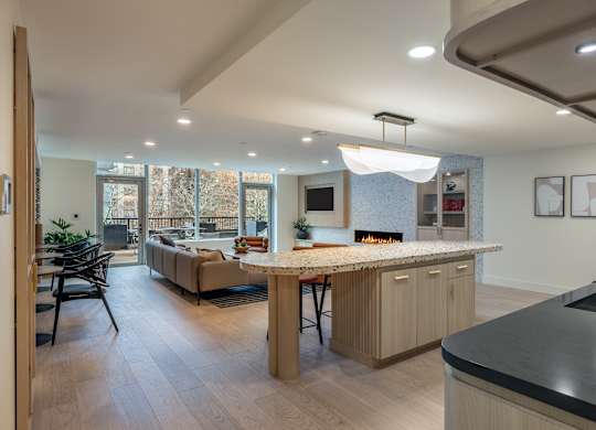 a kitchen with a bar and a living room with a fireplace