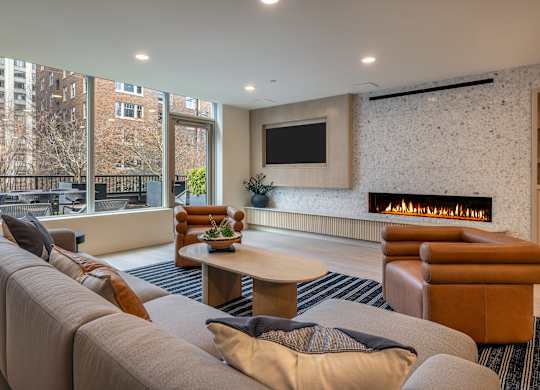 a living room with a couch and a coffee table and a fireplace
