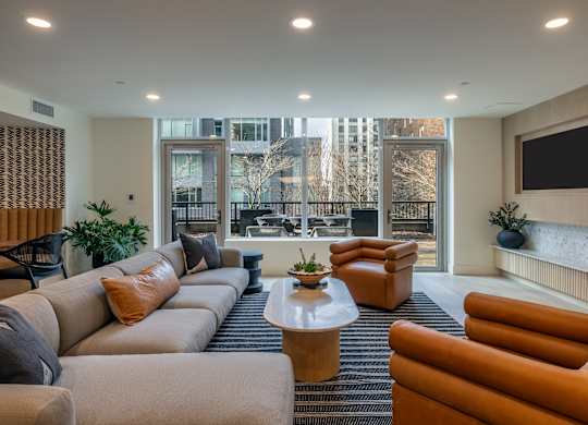 a living room with couches and chairs and a television