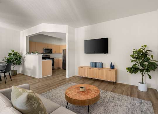 A modern living room with a flat screen TV mounted on the wall.