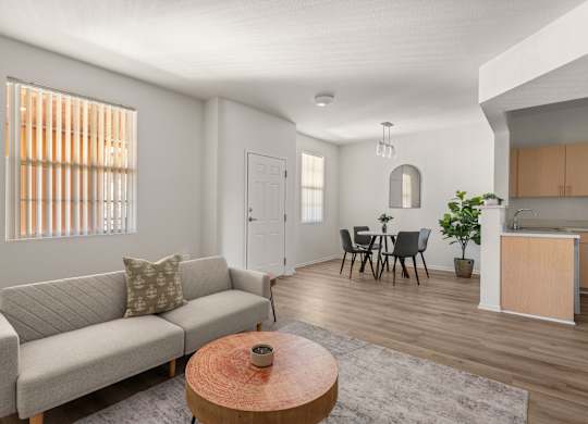 A living room with a grey couch and a wooden coffee table.