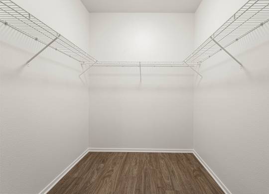 Closet  with white walls and wooden floor.