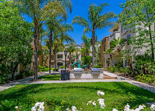 A sunny day in a well-maintained garden with white flowers and greenery.