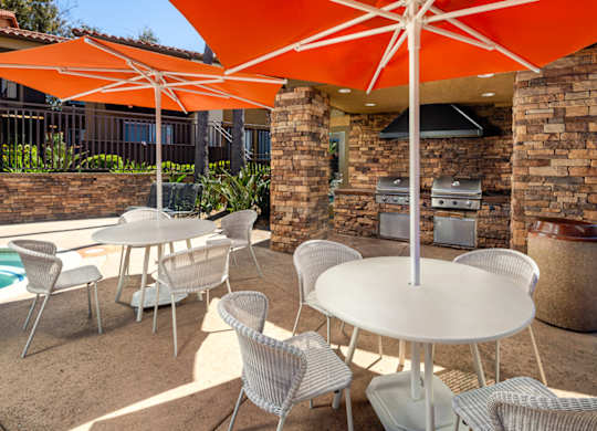 Patio with tables and chairs and umbrellas at Bella Terra, Vista, CA, 92081
