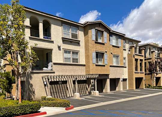 A row of apartment buildings with a clear blue sky above.