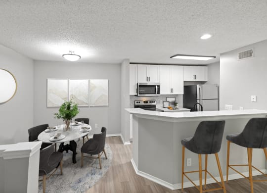 an open kitchen and dining room with a table and chairs