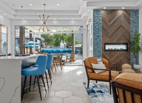 a lobby with a bar and a pool in the background
