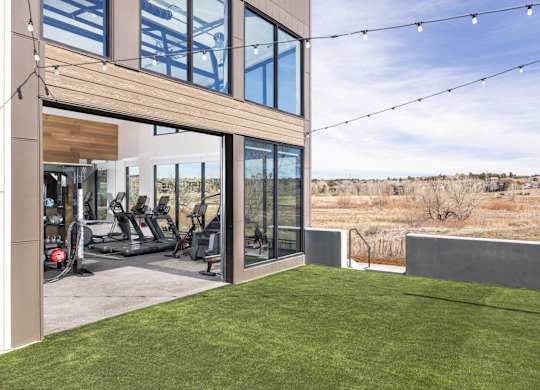 A modern house with a gym and a view of the desert.