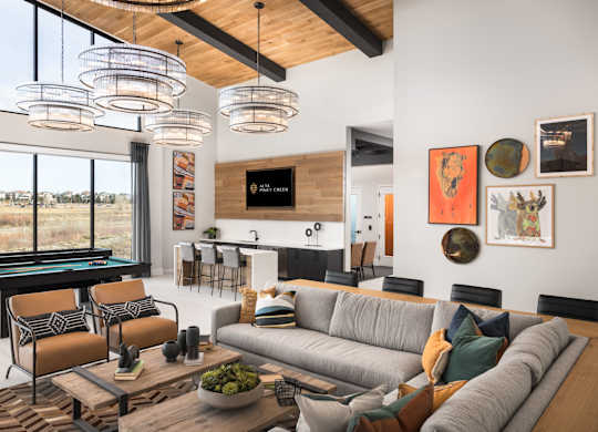 A living room with a pool table and a couch.