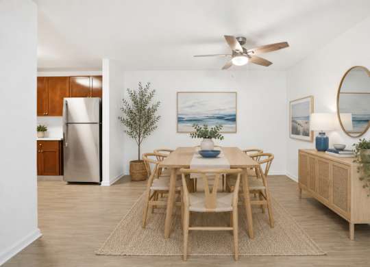 A dining room with a wooden table and chairs.