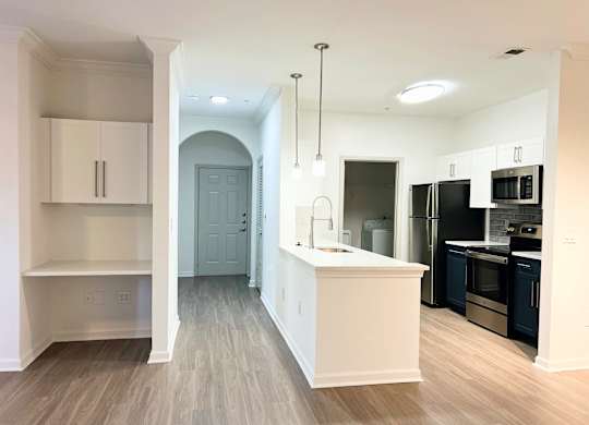 a renovated kitchen with a large island and black appliances