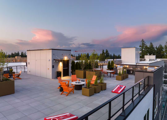 a roof top terrace with orange chairs and potted plants at Ion Town Center, Shoreline, WA