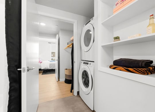 a small laundry room with a washer and dryer at Ion Town Center, Shoreline, WA