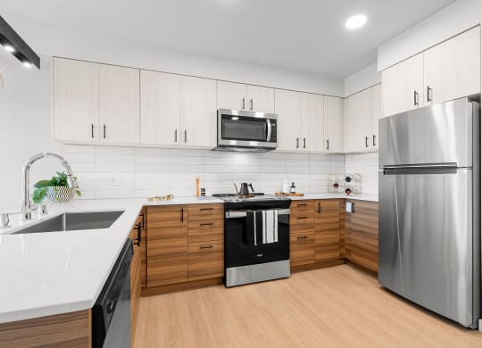 a kitchen with white countertops and wooden cabinets at Ion Town Center, Shoreline, WA