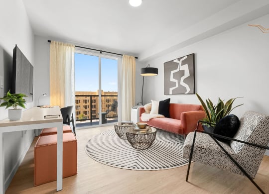 a living room with white walls and hardwood floors and a sliding glass door that leads to at Ion Town Center, Shoreline, WA