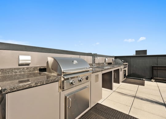 a kitchen with stainless steel appliances and granite counter tops at Ion Town Center, Shoreline, WA