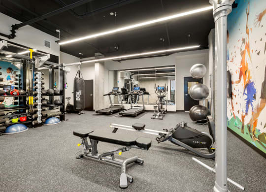 a large fitness room with weights and other exercise equipment at Ion Town Center, Washington