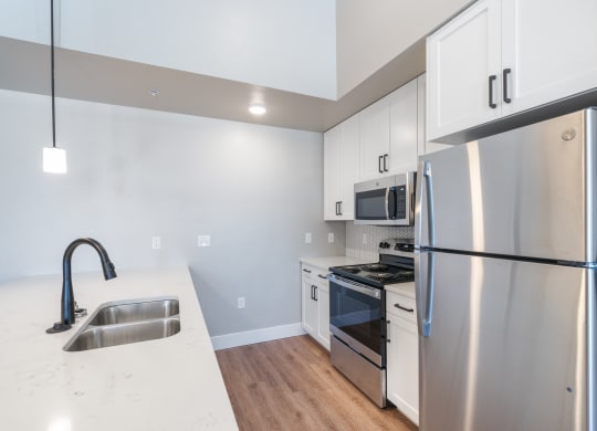 a kitchen with stainless steel appliances and white cabinets