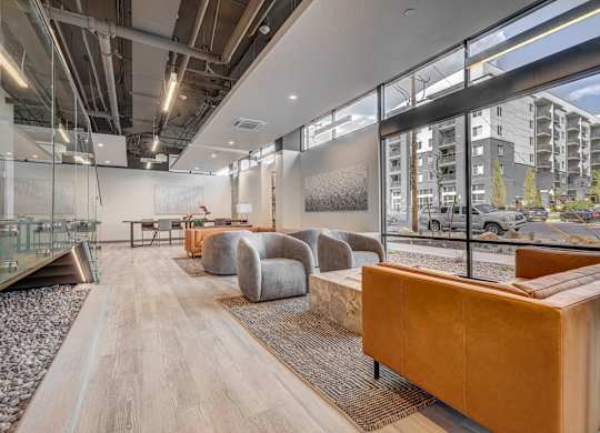 A modern office space with wooden floors and glass walls.